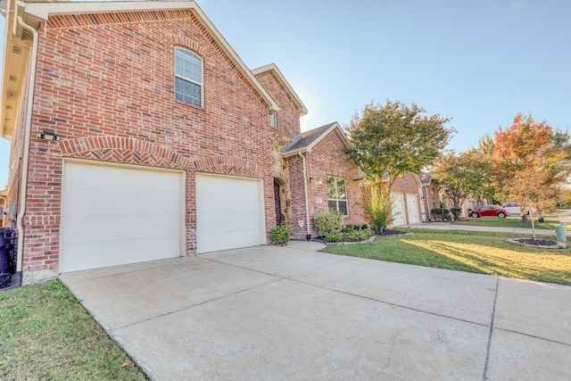 front facade with a front yard and a garage