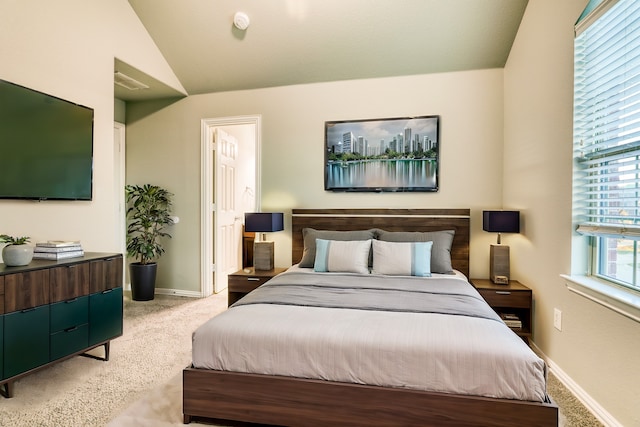 carpeted bedroom featuring vaulted ceiling