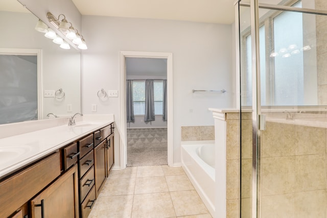 bathroom featuring plus walk in shower, tile patterned flooring, and vanity