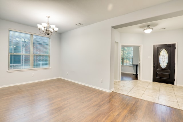 foyer featuring an inviting chandelier and light hardwood / wood-style flooring