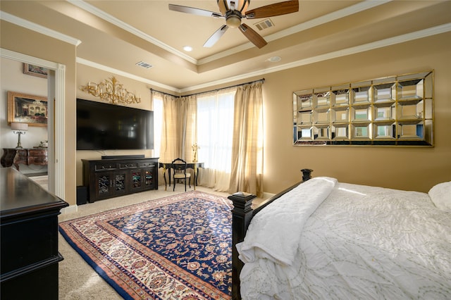 bedroom featuring carpet flooring, a raised ceiling, ceiling fan, and ornamental molding