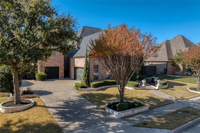 view of front facade featuring a garage and a front lawn