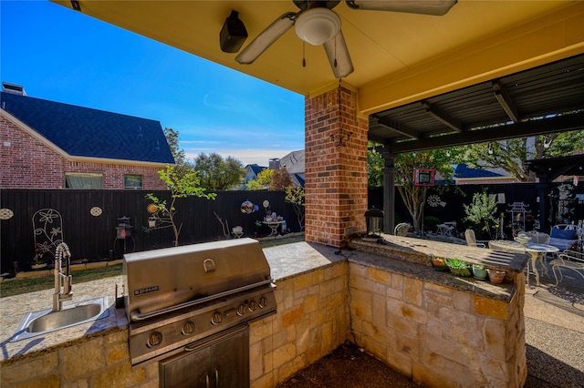 view of patio featuring sink, area for grilling, ceiling fan, and a grill