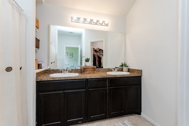 bathroom featuring tile patterned flooring and vanity