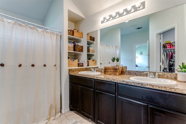 bathroom with tile patterned flooring and vanity