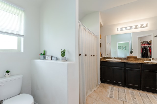 bathroom featuring toilet, vanity, and tile patterned floors