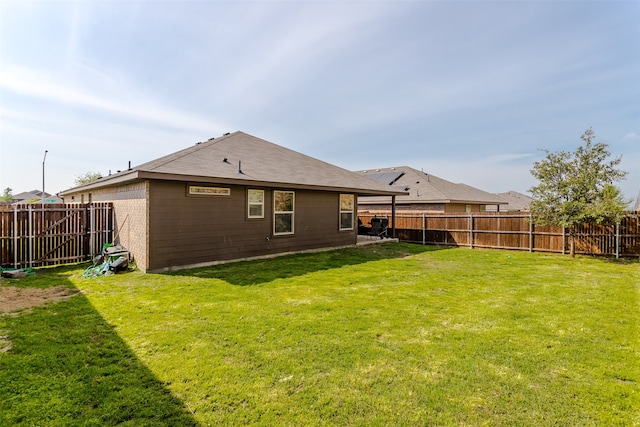 rear view of house with a yard