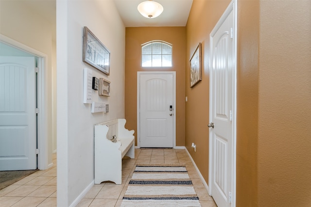 doorway featuring light tile patterned flooring