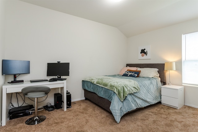 bedroom with multiple windows, light colored carpet, and vaulted ceiling