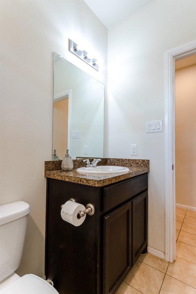 bathroom featuring toilet, vanity, and tile patterned floors