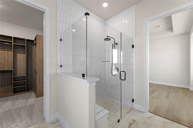 bathroom with a shower with door