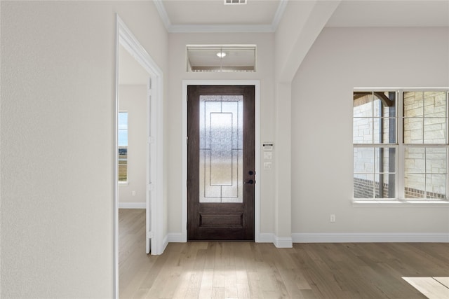 unfurnished dining area with a wealth of natural light, a chandelier, and light hardwood / wood-style floors