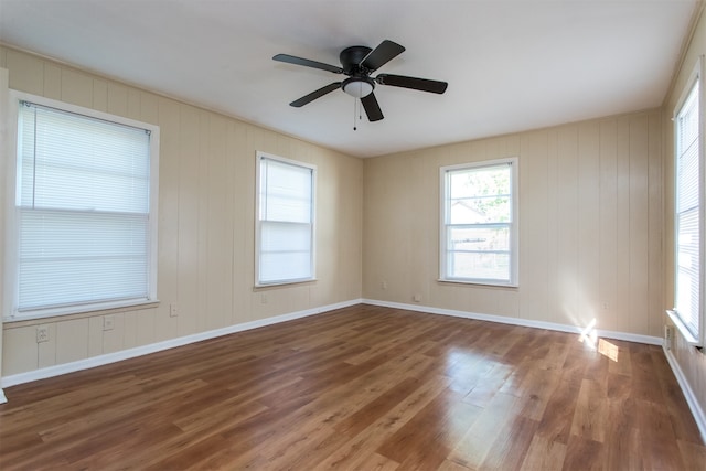 unfurnished room featuring ceiling fan and dark wood-type flooring