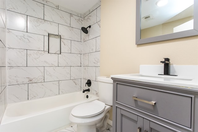 full bathroom with vanity, tiled shower / bath combo, and toilet