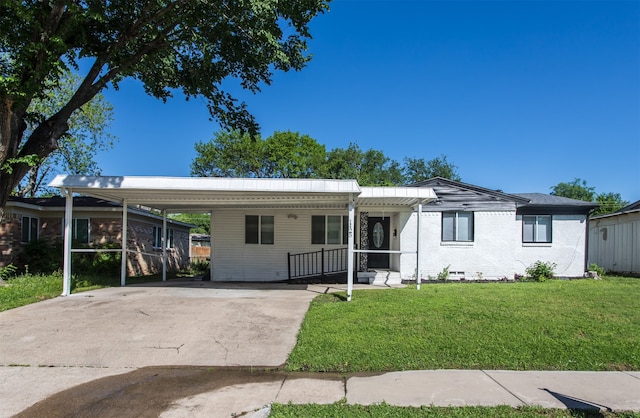 single story home with a front lawn and a carport