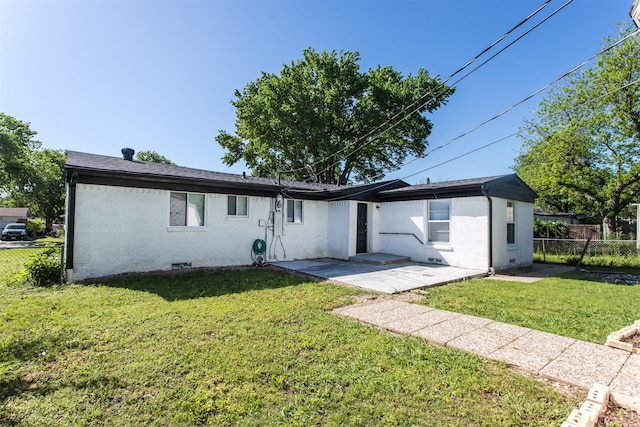 ranch-style home with a patio and a front lawn