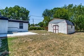 view of yard with a patio area and a storage shed