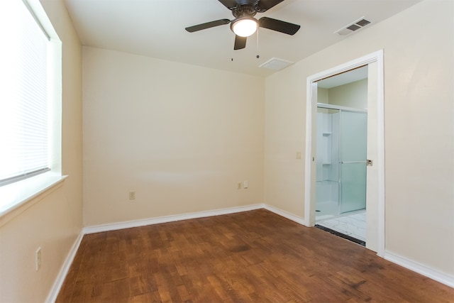 unfurnished bedroom featuring dark hardwood / wood-style floors and ceiling fan