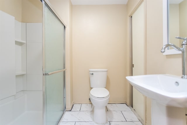 bathroom featuring toilet, walk in shower, and sink