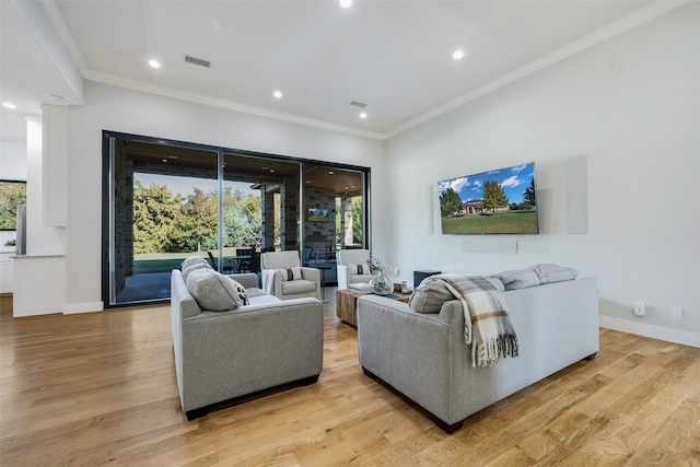 living room featuring crown molding and light hardwood / wood-style floors