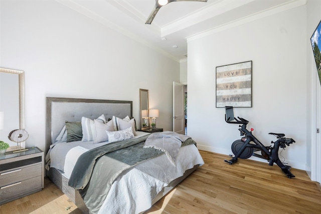 bedroom with crown molding, ceiling fan, and light hardwood / wood-style floors