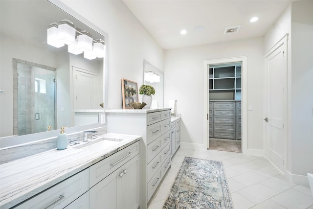 bathroom with vanity and a shower with shower door