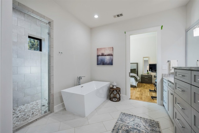 bathroom with tile patterned floors, vanity, and independent shower and bath