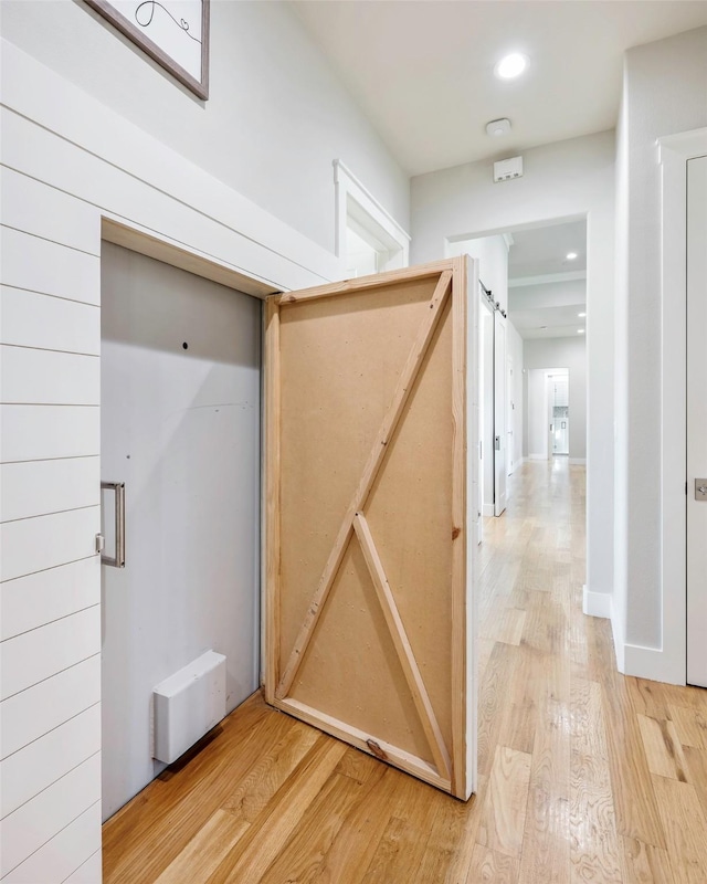 hallway with hardwood / wood-style floors