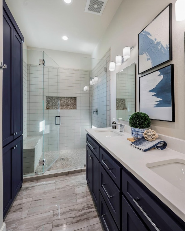 bathroom featuring vanity and an enclosed shower