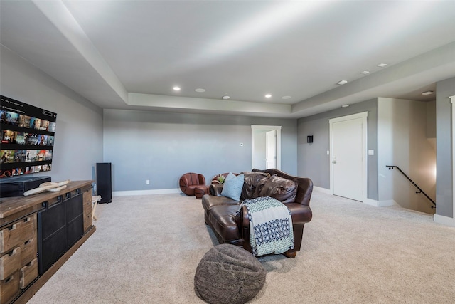 living room with light colored carpet and a tray ceiling