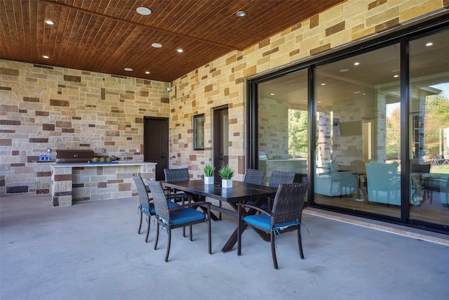 view of patio with exterior kitchen and an outdoor bar