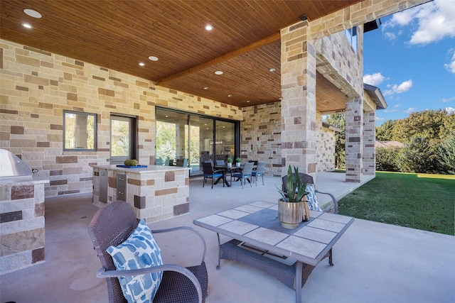 view of patio with an outdoor bar and an outdoor kitchen