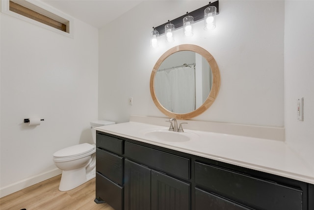 bathroom featuring vanity, toilet, and wood-type flooring