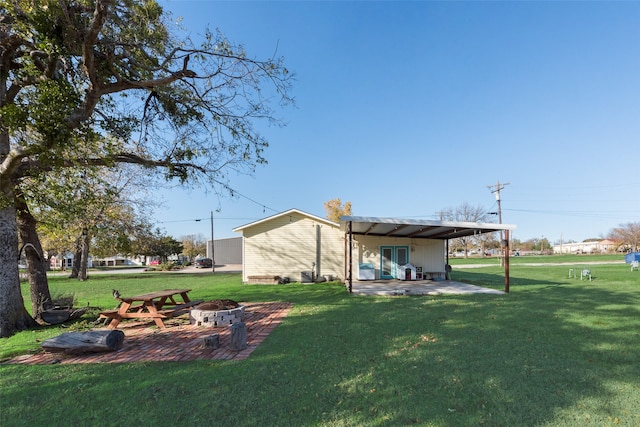 view of yard with a patio and a fire pit