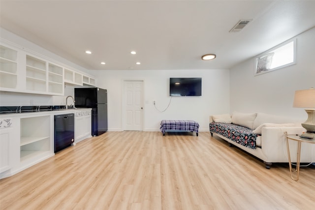 living room featuring light hardwood / wood-style flooring and sink