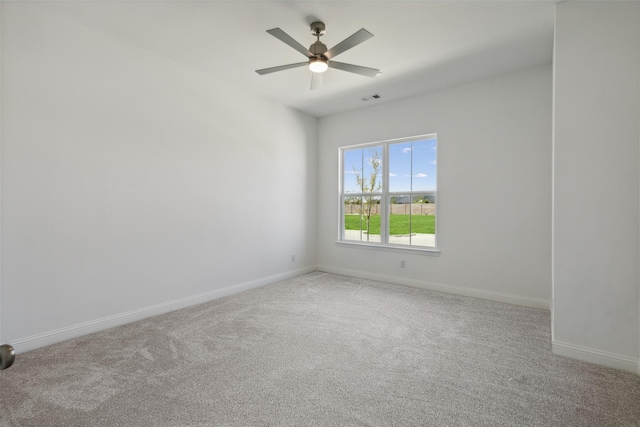 spare room featuring ceiling fan and light colored carpet