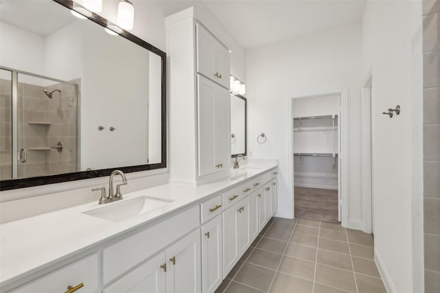 bathroom featuring vanity, an enclosed shower, and tile patterned flooring