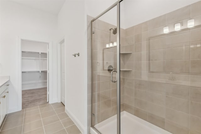 bathroom with vanity, tile patterned flooring, and a shower with shower door