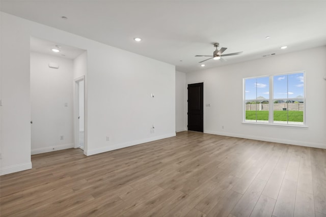 spare room featuring ceiling fan and light hardwood / wood-style flooring