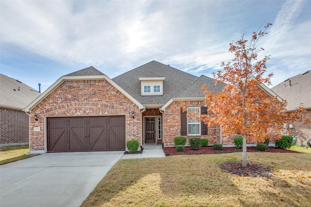 view of front facade featuring a garage and a front lawn