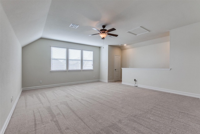 unfurnished room with light carpet, vaulted ceiling, and ceiling fan