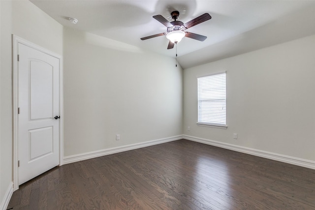 spare room with dark hardwood / wood-style flooring and ceiling fan