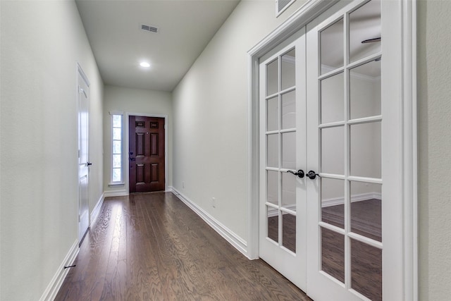 doorway with dark wood-type flooring and french doors