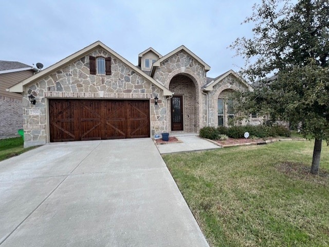 view of front of property featuring a garage and a front lawn