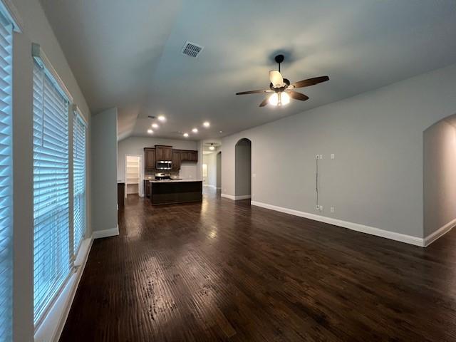 unfurnished living room with ceiling fan and dark hardwood / wood-style flooring