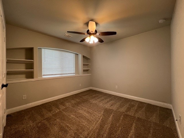 carpeted empty room featuring built in features and ceiling fan