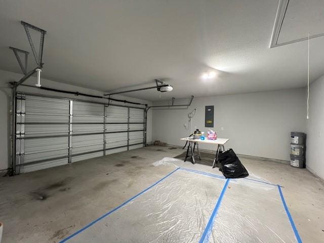 garage with a garage door opener and electric panel