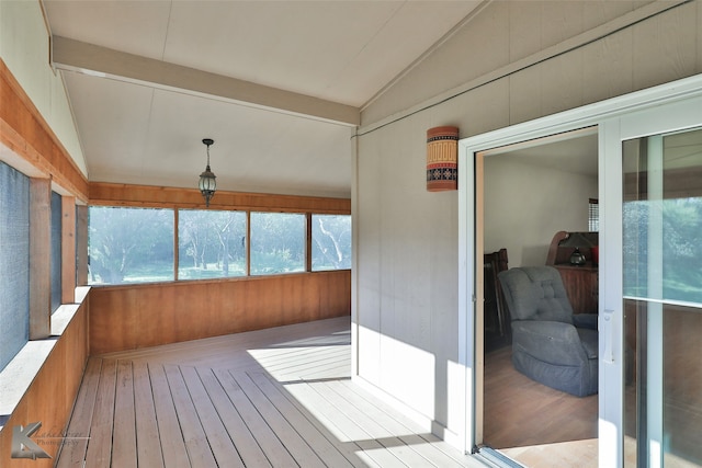 sunroom / solarium with lofted ceiling with beams and a healthy amount of sunlight