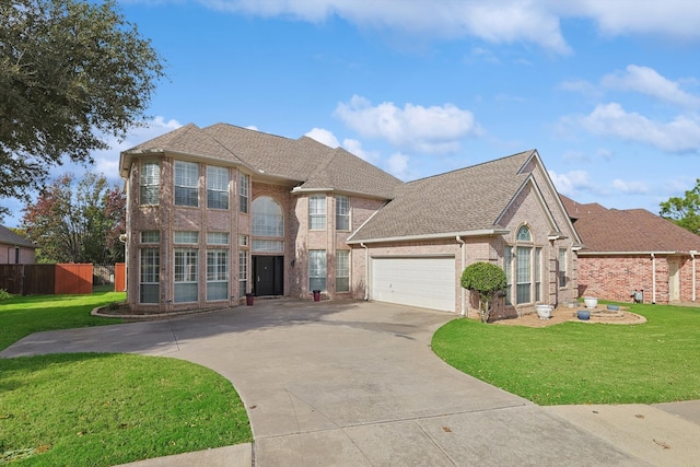 view of front of house featuring a garage and a front lawn