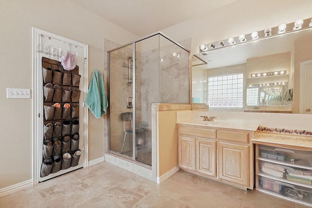 bathroom featuring tile patterned flooring, vanity, and an enclosed shower